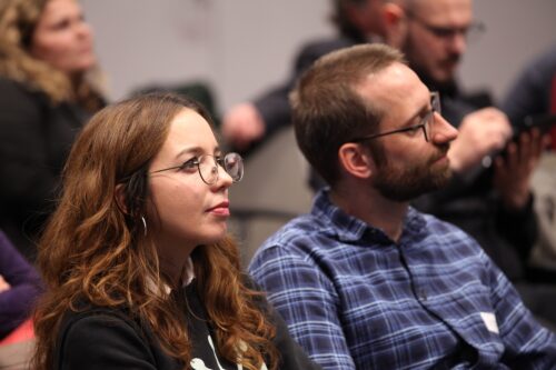 Two participants closely listening to the lecturers’ explanations